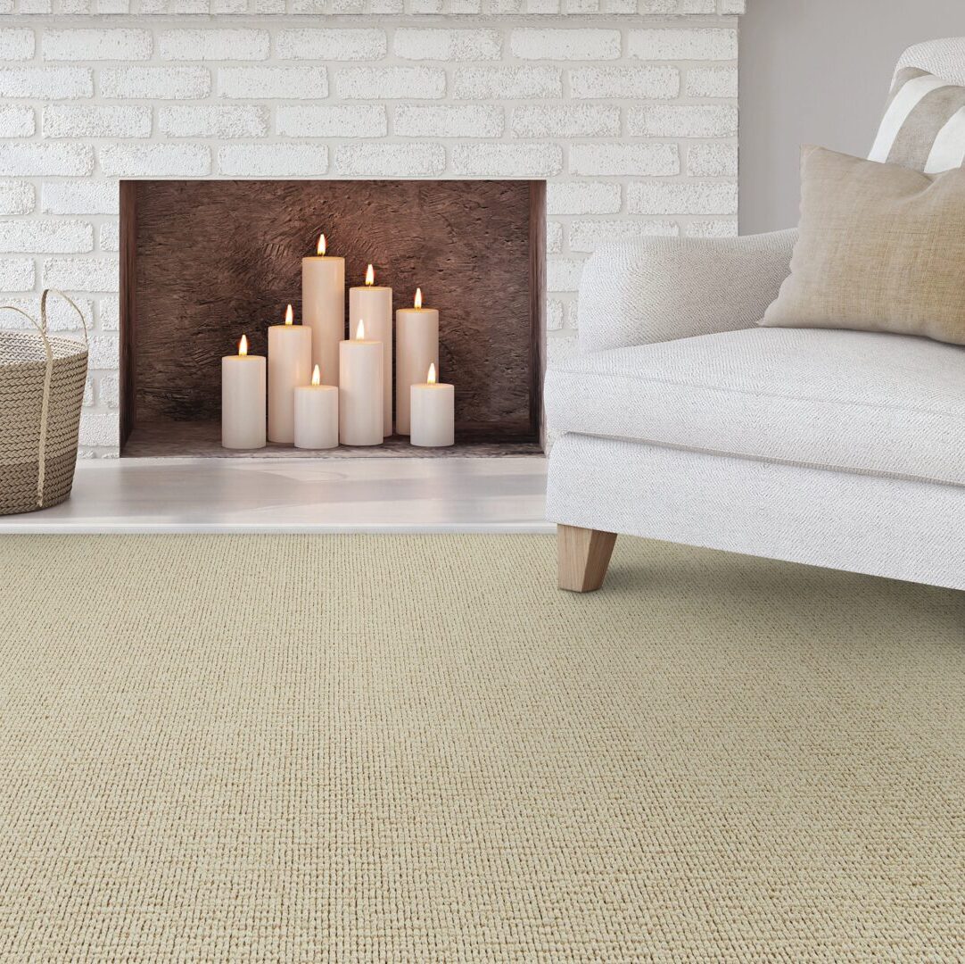 Living room with a white armchair on DH Floors Nature's Glen carpet