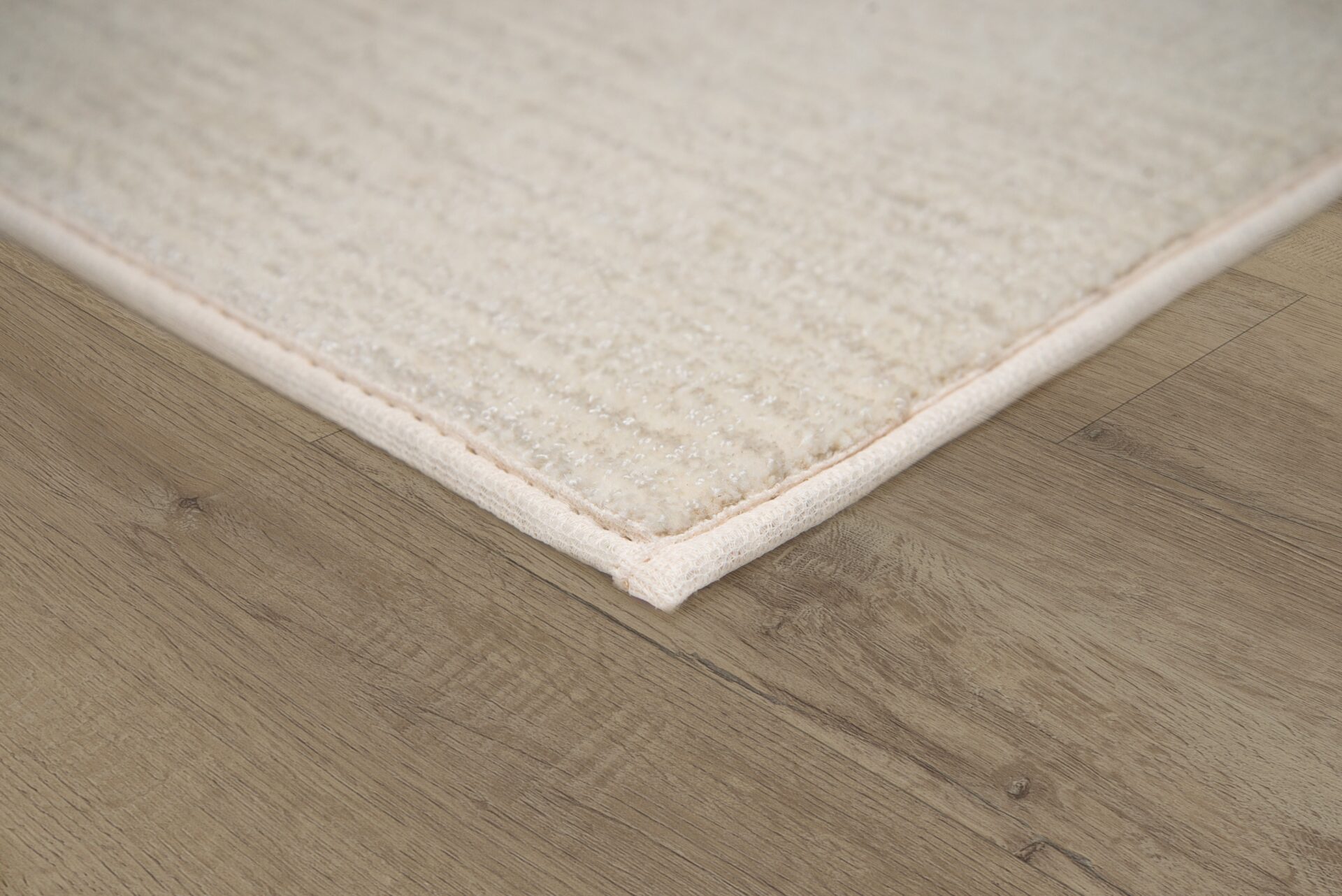 Rug edge finished with synthetic binding